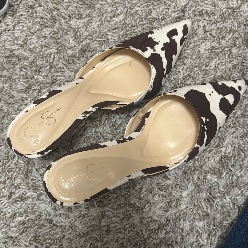 Dark brown/white cow print microsuede mules.
